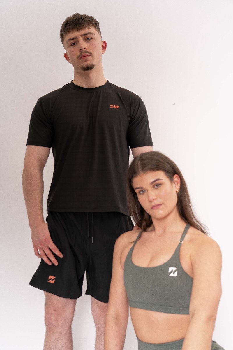Men and women wearing REP clothing gym sets – reps clothing uk gym tops and shorts.