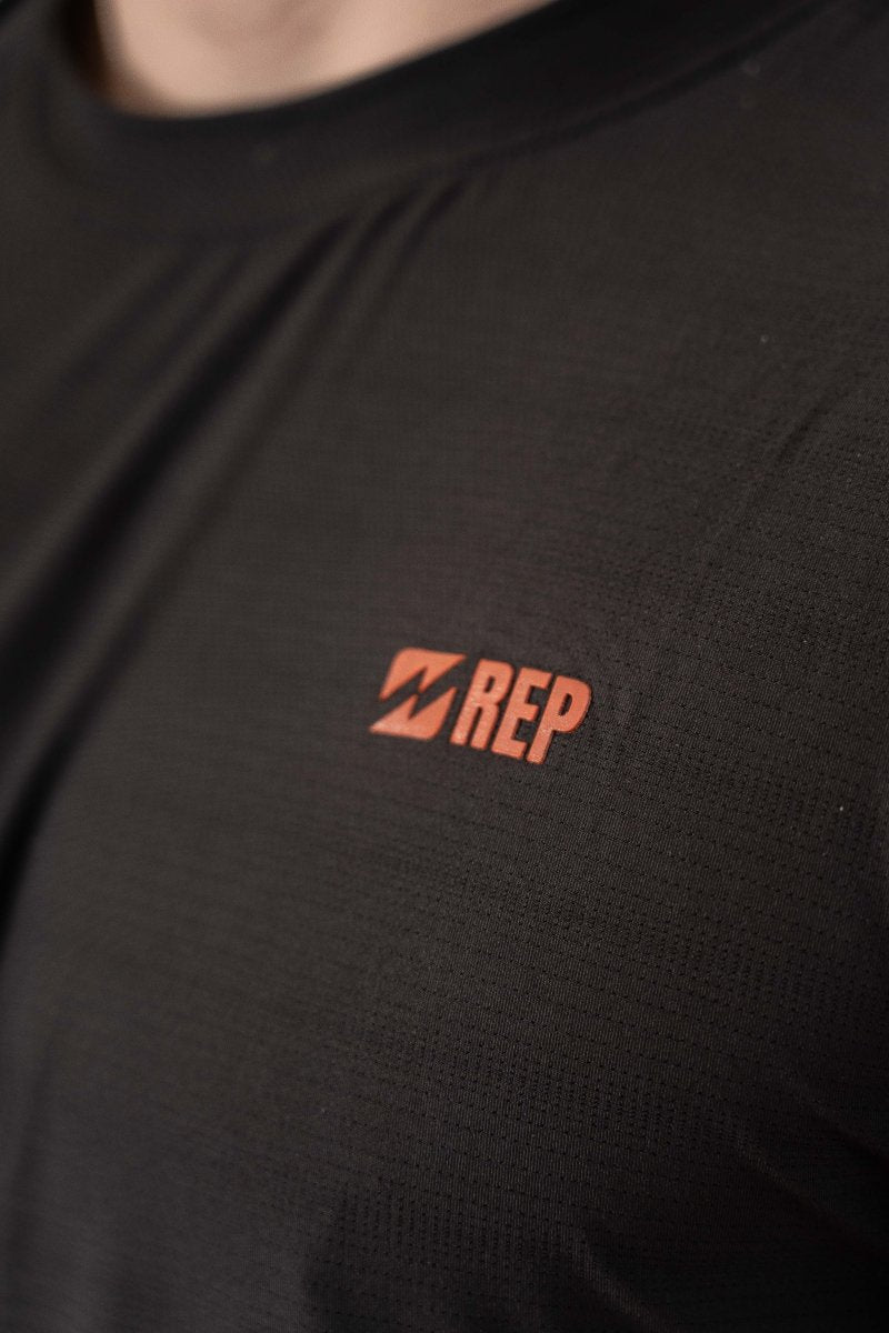 Close-up of REP logo on men’s gym top – rep clothing, represent t shirt.