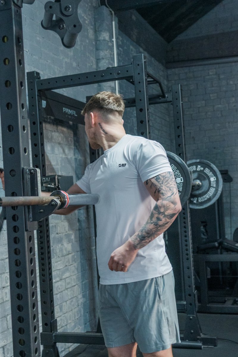 REP grey gym top styled by male model – gym top men, rep clothes, represent clothing