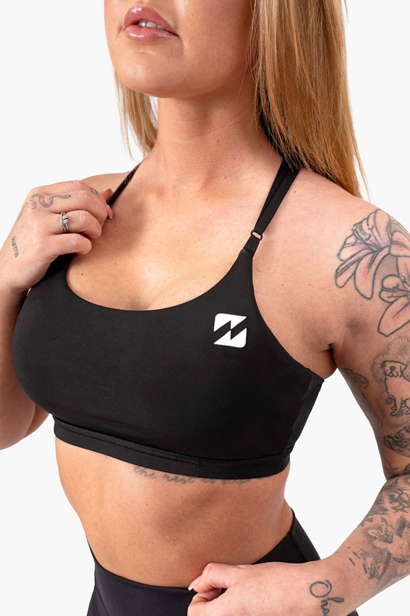 black sports bra and shorts styled post-workout, womens gym tops, represent, padded sports bras for women